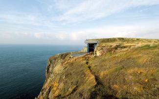 Building with green roof on a cliff