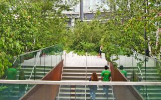 People walking up a staircase onto the elevated park